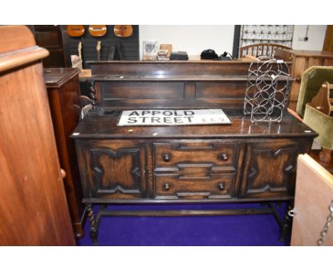 A vintage dark stained oak sideboard with rack