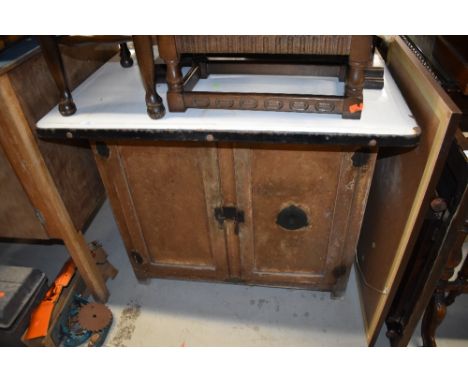 A vintage kitchen or industrial cabinet, having enamelled top, and vented double cupboard under