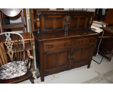 A dark stained Ercol style court cupboard, width approx. 126cm