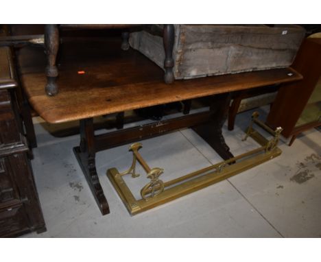 A traditional dark stained Ercol style refectory style table