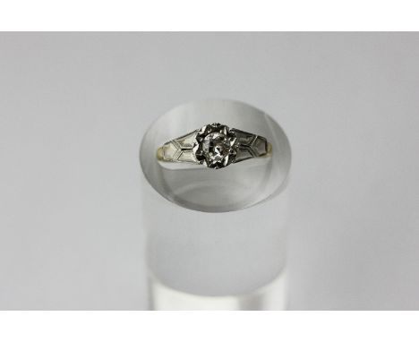 A diamond single stone ring illusion set with a round brilliant cut in platinum and gold, the diamond approximately 25pts