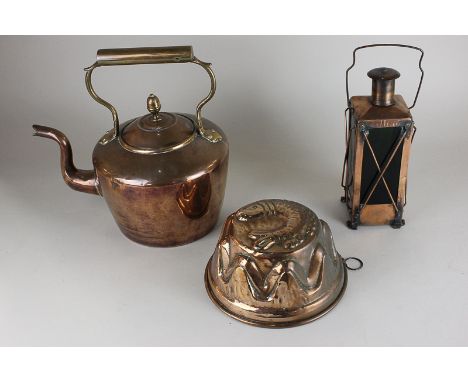 A copper jelly mould with fish design, a copper kettle and a novelty musical copper lantern