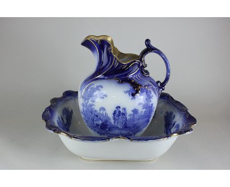 A Victorian Burslem Watteau jug and basin decorated with figures playing instruments and seated in idyllic settings, in blue 