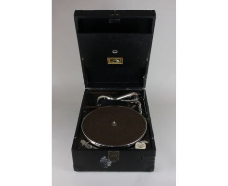 An HMV portable record player with various long playing records