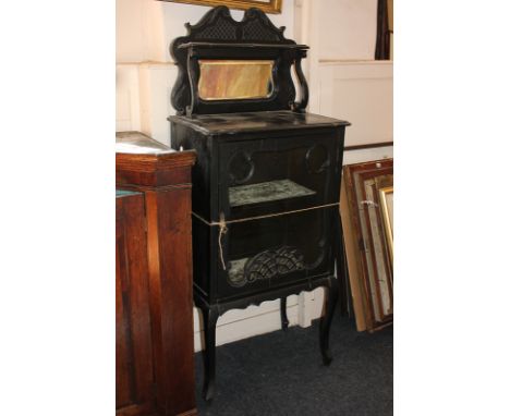 An Art Nouveau ebonised display cabinet with raised shelf back and mirror above single glazed door, on cabriole legs, 55cm