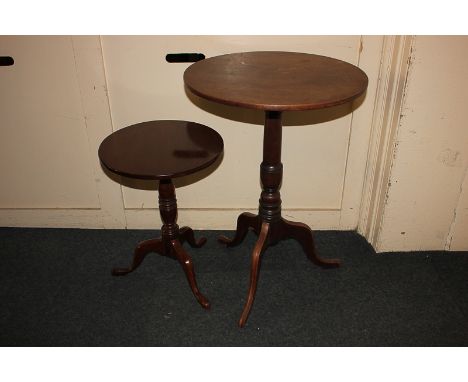 A George III style mahogany wine table with circular tilt-top on turned baluster stem with ebonised trim, on outswept tripod 