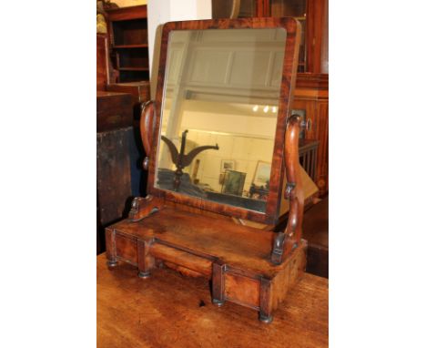 A Victorian mahogany dressing table mirror with rectangular framed glass on scroll supports and box base with three drawers a