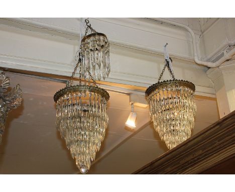A pair of brass and cut glass chandelier light shades with five graduated tiers, 45cm, together with a single tier fitting (s