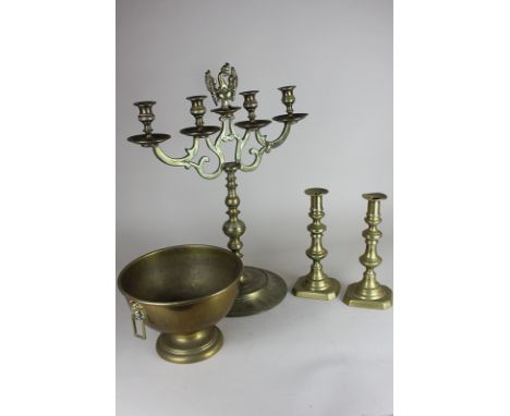 A brass four-light candlestick, 50cm high, a pair of single candlesticks and a circular pedestal bowl with mask drop handles,