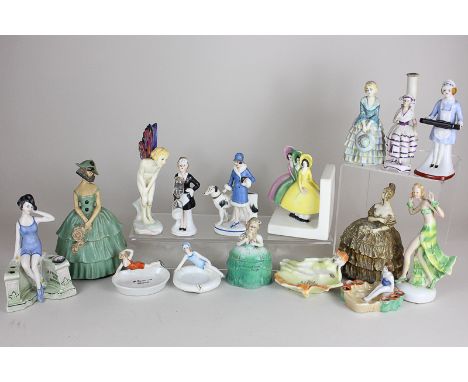 A collection of porcelain Art Deco style figurines of ladies in bathing costumes on small dishes, including a book end, egg t