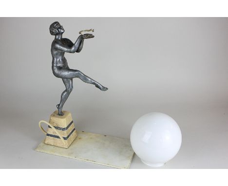 An Art Deco style lamp base with a cast metal female nude, leg and arms outstretched, on glass and hardstone base, 40cm, (a/f