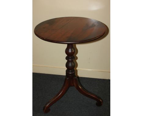 A circular mahogany occasional table on turned stem and outswept tripod legs, 51cm