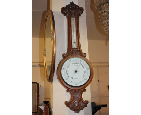 A 20th century oak cased banjo barometer, the dial marked Stebbing Southampton, with thermometer above and carved design