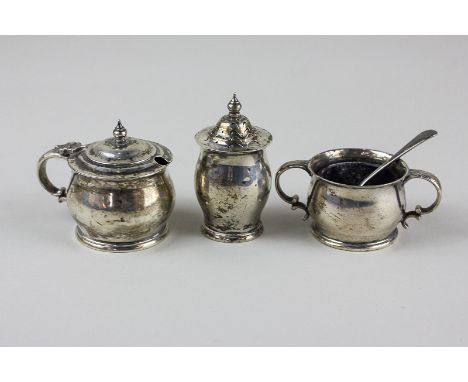 An early 20th century Irish silver three piece cruet set, to include a mustard pot, salt and pepper, Dublin 1918 and a Sheffi