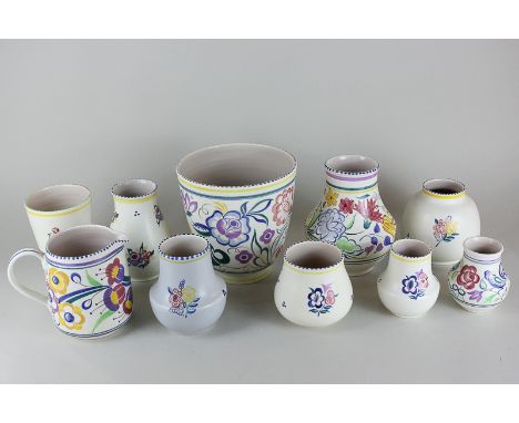 A Poole Pottery jardiniere, together with nine Poole Pottery vases and jugs, all in various floral designs