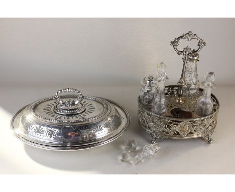 A silver plated bottle cruet stand, oval shape with spaces for six glass cruets (four present and in poor condition), with ce