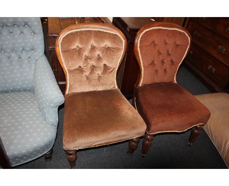 Two similar Victorian mahogany framed button back chairs, with balloon shaped backs, on turned front legs and castors