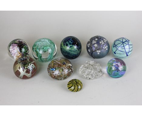 A collection of ten various glass paperweights including Olera 'Oriental Blossom' and Caithness 'Moon Crystal'