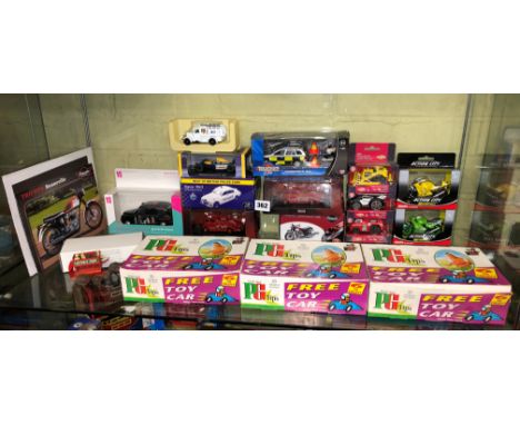 SHELF OF BOXED DIECAST MODEL FIRE ENGINES, F1 CAR, EMERGENCY VEHICLES , BLACK CAB AND THREE PACKETS PG TIPS TOY CAR SETS