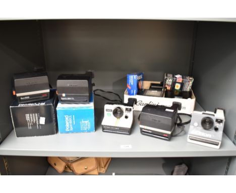 A collection of Polaroid Cameras. A boxed Polaroid Spirit 600CL, a boxed Polaroid Sun 600 LMS, a Polaroid 1000 Land Camera, a