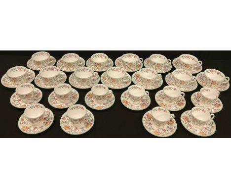 A Minton Haddon Hall pattern tea set comprising thirteen teacups and saucers; a set of ten Minton Haddon Hall pattern coffee 