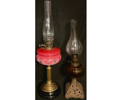 A Victorian brass and opaque glass table oil lamp, c.1890; another, cast iron base (2) 