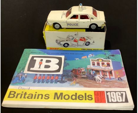 Toys &amp; Juvenalia - Dinky Toys 255 Ford Zodiac Police car, boxed and two Britains Models 1967 catalogues (3) 