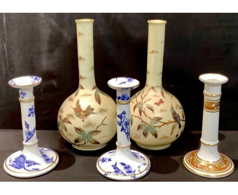 A pair of Royal Worcester table candlestick, printed in underglaze blue with birds in flight, c.1880; another, similar candle