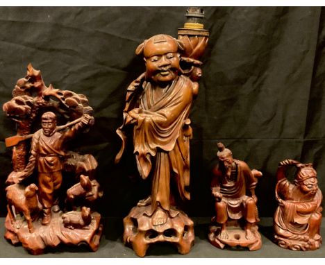 A Chinese carved hardwood table lamp, as Shou Loa, 40cm high; others, figure with sheep; bearded immortal; seated sage (4) 