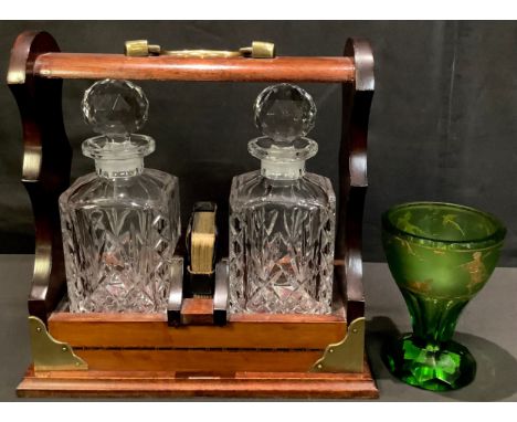 A mahogany two bottle tantalus, cut glass decanters, seprated by a pack of playing cards, 28cm high; an Art Deco style green 