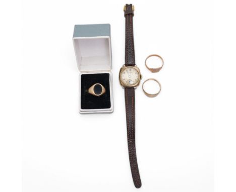 Two gold signet rings, gold black onyx signet ring and a gold manual wind wristwatch, on leather strapCondition Report:9ct no