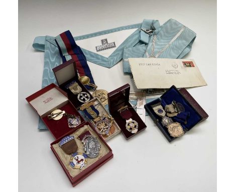 Three Masonic silver and enamel jewels, another silver medal, various others including some Cornish, and a Masonic apron.