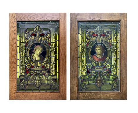 A pair of 19th century stained glass panels, centred with a male and a female portrait and each with a pedestal below and fla