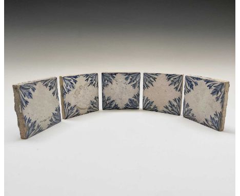 A set of five Leach pottery tiles, with blue and white foliate decorated corners, impressed seal marks, each 10.3cm square (5
