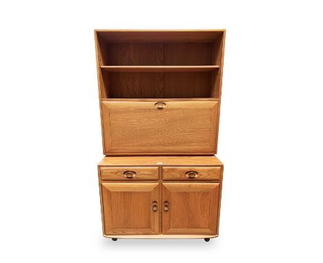 An Ercol light elm drinks cabinet, fitted with a shelved upper section above a fall front and with two drawers and two doors 