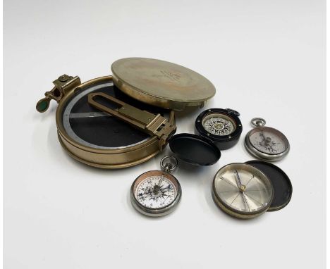 A brass cased circular pocket compass, diameter 5cm, together with two US 'Leedawl' compasses, a black finished pocket compas