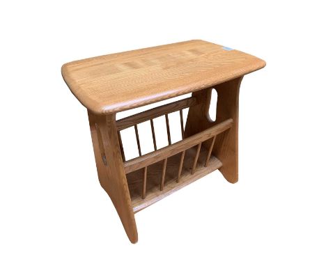 An Ercol light elm magazine rack and occasional table, 1970s, with pierced ends and spindle supports, height 50cm, width 55cm