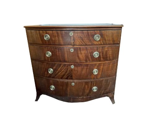 A Regency mahogany bow front chest of four graduated long drawers, with ebony stringing, brass wreath pull handles and raised