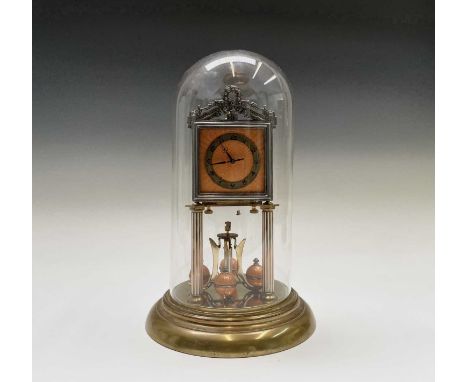 A Jahresuhrenfabrik brass torsion clock, 1920s, with Art Deco orange enamel decorated dial and weights, the movement stamped 