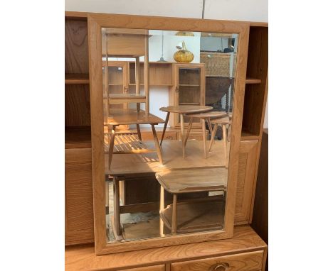 An Ercol light elm rectangular wall mirror with bevelled plate. 94 x 61cm.