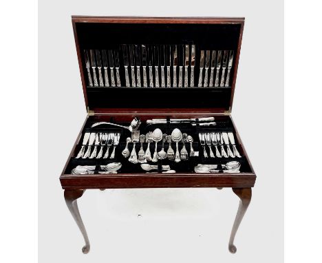 A Kings pattern canteen of cutlery - 12 place settings plus ladle and carving set - in reproduction mahogany table on stand w