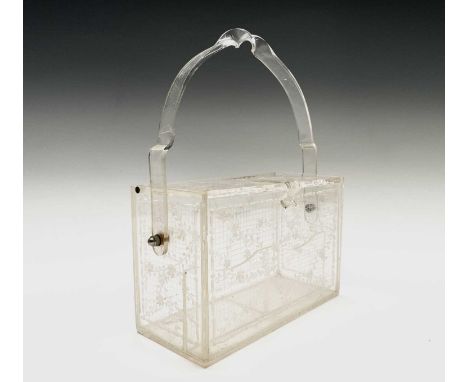A 1950s clear lucite box handbag, having carved floral decoration. Height 11.5cm (24.5cm when handle upright) width 18cm, dep