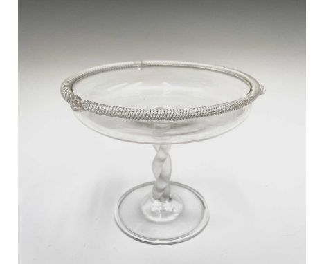 A clear glass tazza, possibly Powell &amp; Sons, Whitefriars, circa 1900, the rim with spiral moulded edge and three applied 