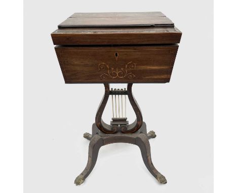 A Regency inlaid rosewood teapoy, enclosing two hinged caddy compartments, applied with brass side ring handles and raised up