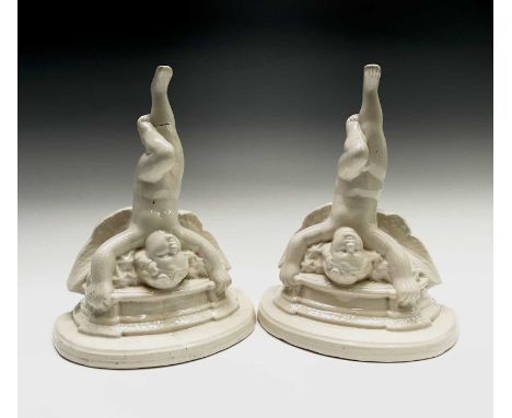 A pair of pottery cherub wall brackets, 20th century, each inscribed F.V., b/stone Poole England, height 29cm.