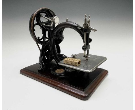 A 'Wilcox &amp; Gibbs Sewing Machine Co.' sewing machine, cased. Case height 30cm, width 36cm, depth 24cm.