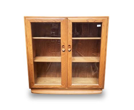 An Ercol light elm bookcase, with two glazed doors enclosing two adjustable shelves, height 97.5cm, width 91cm, depth 29cm.