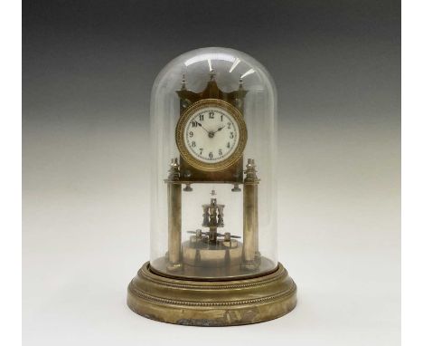 A German brass torsion clock, circa 1900, the circular white enamel dial with Arabic numerals and ornate brass surround, the 