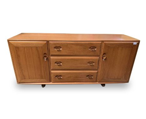 An Ercol light elm sideboard, fitted three central drawers flanked by two cupboards, height 69cm, width 155cm, depth 45cm.