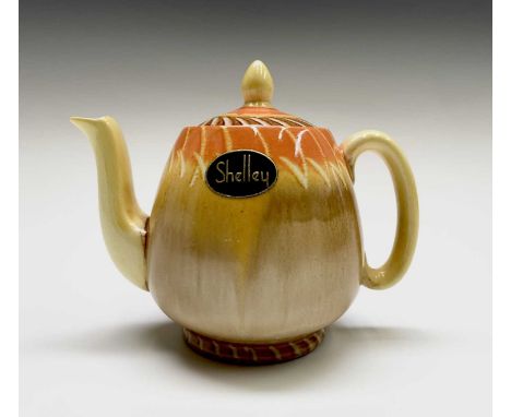 A 1930s Shelley drip ware teapot, with original label. Height 11cm.Condition report: No chips, cracks, crazing, staining or e